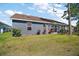 Property boasting a spacious backyard with a well-kept lawn and mature landscaping at 2142 Margarita Dr, The Villages, FL 32159