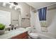 Nicely designed bathroom featuring a vanity with a sink and granite countertops, plus a tub with shower at 2142 Margarita Dr, The Villages, FL 32159