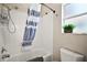 Clean bathroom with a tub/shower combo, white tile, and window with natural light at 2142 Margarita Dr, The Villages, FL 32159