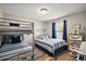 Shared bedroom includes two beds, wood floors, natural lighting, and a seaside theme at 2142 Margarita Dr, The Villages, FL 32159