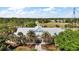Exterior view of a community center surrounded by manicured landscaping and trees at 2142 Margarita Dr, The Villages, FL 32159