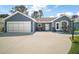 Charming single-story home features a two-car garage and inviting front porch at 2142 Margarita Dr, The Villages, FL 32159