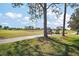 Scenic view of a well-manicured golf course with two golf carts in the background at 2142 Margarita Dr, The Villages, FL 32159