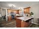 Well-lit kitchen with wood cabinets, granite countertops, stainless steel appliances, and an island with seating at 2142 Margarita Dr, The Villages, FL 32159