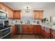 Well-equipped kitchen with wood cabinets, modern appliances, and subway tile backsplash, for cooking and entertaining at 2142 Margarita Dr, The Villages, FL 32159