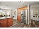 Open kitchen features updated cabinets, stainless steel appliances, and an adjacent breakfast area at 2142 Margarita Dr, The Villages, FL 32159