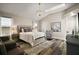 Bright main bedroom with vaulted ceiling, skylight, chandelier, and comfortable seating area at 2142 Margarita Dr, The Villages, FL 32159