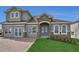 Charming two-story home features stone accents, arched entry, and well-manicured lawn at 2176 Keystone Pass Blvd, Minneola, FL 34715
