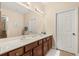 Spacious bathroom featuring double sinks, a large mirror, and a separate shower at 23814 Sardinia Dr, Sorrento, FL 32776