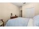 Comfortable bedroom with a light blue comforter, adjacent to closet and bath at 23814 Sardinia Dr, Sorrento, FL 32776