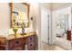 Hallway with decorative furniture and a view into the bedroom with a large window at 23814 Sardinia Dr, Sorrento, FL 32776