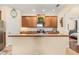Stylish kitchen with stainless steel appliances, wooden cabinets, and a decorative wreath at 23814 Sardinia Dr, Sorrento, FL 32776