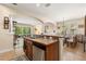 Open-concept kitchen with a breakfast bar, stainless steel dishwasher, and view of the dining and living areas at 23814 Sardinia Dr, Sorrento, FL 32776