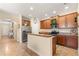 Well-equipped kitchen featuring stainless steel appliances, wood cabinetry, and a breakfast bar at 23814 Sardinia Dr, Sorrento, FL 32776