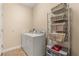 Laundry room features a washer, dryer, and shelving for storage of supplies at 23814 Sardinia Dr, Sorrento, FL 32776