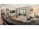 Comfortable living room with hardwood floors and sliding glass doors to screened porch at 23814 Sardinia Dr, Sorrento, FL 32776