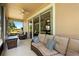 Relaxing screened-in patio featuring a cozy couch, scenic views, and a ceiling fan for added comfort at 23814 Sardinia Dr, Sorrento, FL 32776