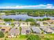 An aerial view of homes near a tranquil lake, surrounded by lush greenery and offering a peaceful residential setting at 25545 Laurel Valley Rd, Leesburg, FL 34748