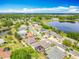 Aerial view showcasing homes with screened pools and patios near a serene lake, surrounded by lush greenery and trees at 25545 Laurel Valley Rd, Leesburg, FL 34748