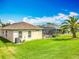 Exterior view of a home with a green lawn and an enclosed patio, showcasing outdoor living at 25545 Laurel Valley Rd, Leesburg, FL 34748