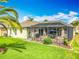 Spacious backyard with a well-maintained lawn and an enclosed patio, perfect for outdoor activities at 25545 Laurel Valley Rd, Leesburg, FL 34748