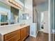 Bathroom featuring a vanity with sink, a walk-in shower, and a large mirror at 25545 Laurel Valley Rd, Leesburg, FL 34748