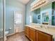 Bright bathroom with a single sink vanity, white door, and blue walls at 25545 Laurel Valley Rd, Leesburg, FL 34748