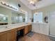 Bright bathroom featuring double sinks, walk-in shower, and a separate soaker tub at 25545 Laurel Valley Rd, Leesburg, FL 34748