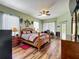 Primary bedroom suite with wood floors, ceiling fan, and a desk perfect for work or study at 25545 Laurel Valley Rd, Leesburg, FL 34748