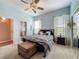 Cozy bedroom features a ceiling fan, carpeted floors, and an en-suite bathroom at 25545 Laurel Valley Rd, Leesburg, FL 34748