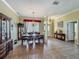 Elegant dining room with decorative chandeliers, large window, and classic furniture at 25545 Laurel Valley Rd, Leesburg, FL 34748