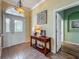 Inviting foyer featuring tile flooring, decorative lighting, and a stylish console table at 25545 Laurel Valley Rd, Leesburg, FL 34748