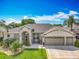 Well-maintained home with lush landscaping, a three-car garage, and inviting curb appeal at 25545 Laurel Valley Rd, Leesburg, FL 34748