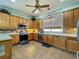 Well-equipped kitchen featuring wooden cabinets, stainless steel appliances, and a tile backsplash at 25545 Laurel Valley Rd, Leesburg, FL 34748