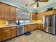 Kitchen featuring wooden cabinets, stainless steel appliances, and ample counter space at 25545 Laurel Valley Rd, Leesburg, FL 34748