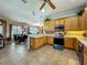 Well-equipped kitchen features wooden cabinets, stainless steel appliances, and open eating area at 25545 Laurel Valley Rd, Leesburg, FL 34748