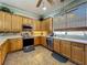 Bright kitchen featuring wooden cabinets, stainless steel appliances, and a tile backsplash at 25545 Laurel Valley Rd, Leesburg, FL 34748