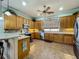 Well-equipped kitchen featuring wooden cabinets, stainless steel appliances, and a tile backsplash at 25545 Laurel Valley Rd, Leesburg, FL 34748
