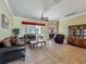 Spacious living room with tile floors and views of the dining area and lanai at 25545 Laurel Valley Rd, Leesburg, FL 34748