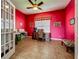 Bright office space with red walls, desk, and large window offering natural light at 25545 Laurel Valley Rd, Leesburg, FL 34748