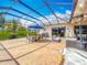 Enclosed patio featuring tile flooring, outdoor furniture, and a view of the landscaped backyard at 25545 Laurel Valley Rd, Leesburg, FL 34748