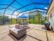 Enclosed patio featuring tile flooring, outdoor furniture, and a view of the landscaped backyard at 25545 Laurel Valley Rd, Leesburg, FL 34748