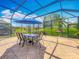 Enclosed patio with a dining table and chairs, offering a perfect space for outdoor meals and relaxation at 25545 Laurel Valley Rd, Leesburg, FL 34748