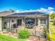 Enclosed patio featuring tile flooring, outdoor furniture, and access to the manicured backyard at 25545 Laurel Valley Rd, Leesburg, FL 34748
