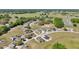 An aerial view shows the neighborhood, surrounding landscape, and the home at 2581 Se 75Th Blvd, Bushnell, FL 33513