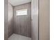 Bathroom featuring modern gray tiled shower and white walls at 2581 Se 75Th Blvd, Bushnell, FL 33513