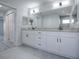 Bright bathroom features a double granite vanity, matte black hardware, and tiled walk-in shower at 2581 Se 75Th Blvd, Bushnell, FL 33513