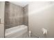 Bathroom featuring modern gray tiling, trim, and bathtub at 2581 Se 75Th Blvd, Bushnell, FL 33513