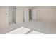A bedroom with neutral walls, open doorways, and a large window at 2581 Se 75Th Blvd, Bushnell, FL 33513
