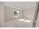 A light-filled bedroom showcasing a large window, tray ceilings, and neutral-colored walls at 2581 Se 75Th Blvd, Bushnell, FL 33513